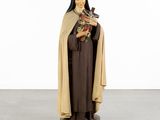 a statue of a woman holding a cat in her hands