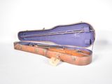 a guitar case that is open on a white surface