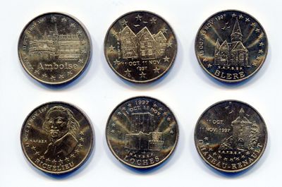 six different types of coins are shown on a white surface