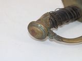 a close up of a metal object on a white surface