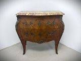 a small chest of drawers with a marble top