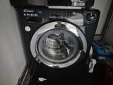 a washing machine in the corner of a room