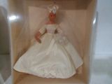 a doll in a box that has a dress on it