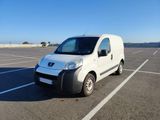 a small white van parked in a parking lot
