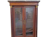 a wooden cabinet with glass doors and a marble top