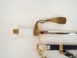 two different types of swords on a white surface