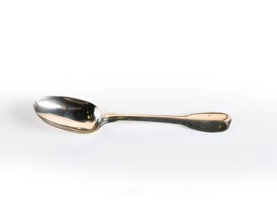 a spoon that is sitting on a white surface