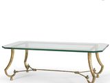 a glass coffee table with gold metal legs and a glass top