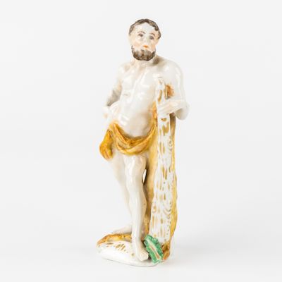 an old figurine of a man holding a surfboard on a white surface