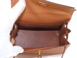 a person holding a brown purse with a white glove on it