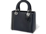 a black handbag with studded handles on a white background