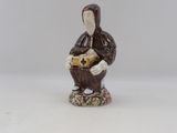an image of a figurine of a woman with a basket of flowers