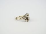 a white gold ring with a flower design on the side