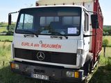 a truck that is parked in the grass in the field
