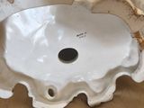 a white porcelain bowl with a flower decoration on it