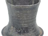 a black vase that is sitting on a white surface