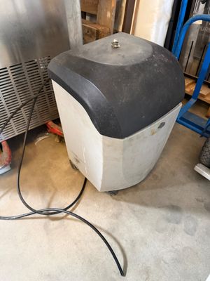 a small ice chest with a hose attached to it