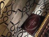 a close up of the inside of a brown and white purse