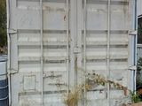 a large white container sitting in the middle of a yard