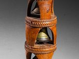 an image of a wooden vase with a bell on top of it