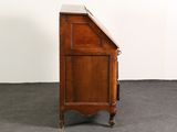 a small wooden cabinet with a marble top