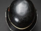 a close up of a black helmet on a black surface