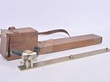 a small wooden box with a metal handle and a handle on it