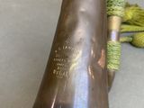a brass trumpet that is sitting on a table