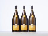 three bottles of wine sitting on top of a table