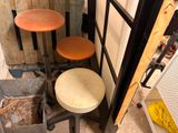 three stools that are sitting next to each other in a room