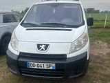 a white van that is parked next to a silver car