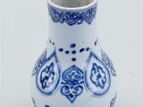 a blue and white vase with a design on it