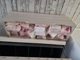 a lot of bags of food sitting on top of a shelf