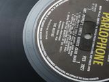 a black record with a yellow label on it