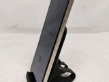 an iphone is sitting on top of a stand on a white surface