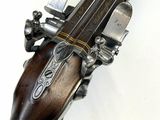 an old gun with a wooden handle on a white background