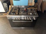 a stove that is sitting in the middle of a room