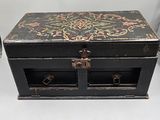 a small black box with a floral design on it