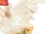 a figurine of a rooster with a red beak
