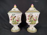 two vases with birds and flowers painted on them on a black background