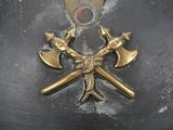 a close up of a helmet with two crossed axes on it