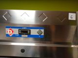 a close up of a stainless steel oven with a blue and white label