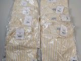 two pairs of yellow and white striped shirts wrapped in plastic