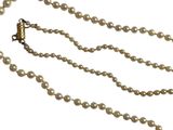 gros plan d'un collier de perles sur fond blanc