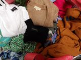 a suitcase full of clothes and a backpack on the floor