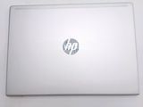 a white laptop with a hp logo on the screen