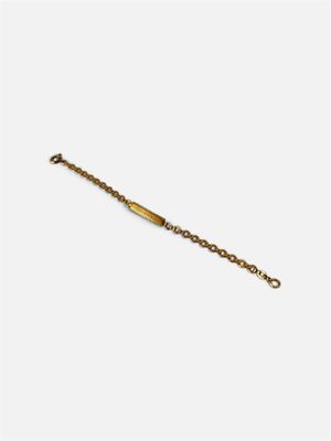 gros plan d'un bracelet en or sur fond blanc