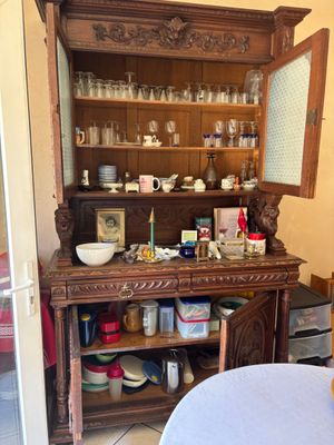 a wooden china cabinet with a glass door open