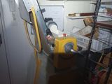 a yellow machine that is sitting in the corner of a room