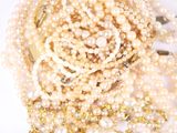 a pile of pearls on a white surface